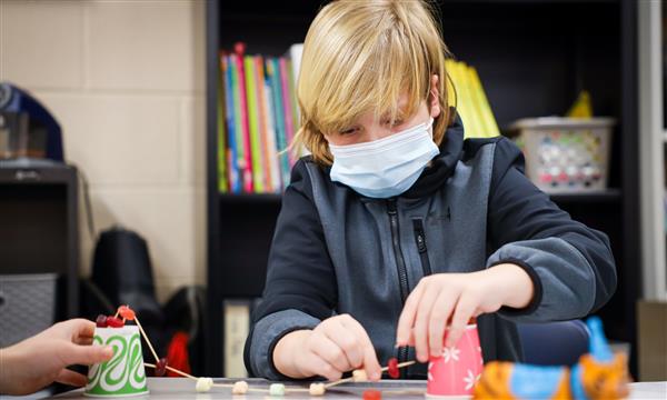 student works to build a bridge